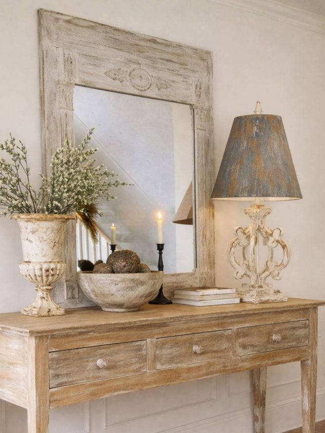 Whitewashed carved wood mirror with candlelight