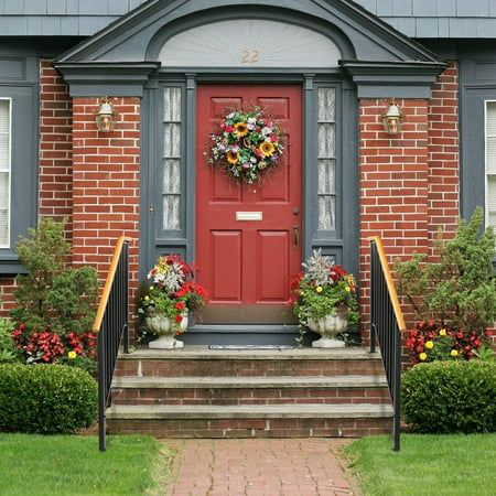 Brick entry with a sunflower-style wreath