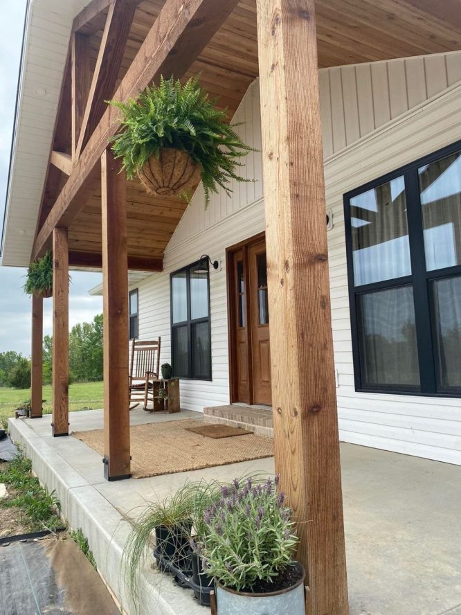 Hanging fern baskets by the cedar-post porch