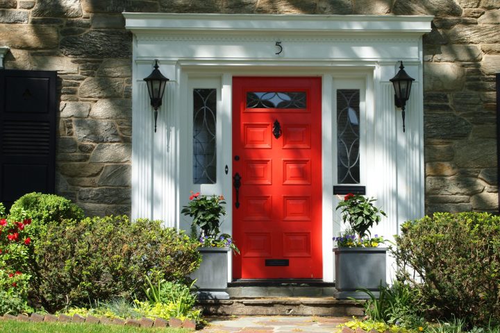Red Door Beneath a White Portico