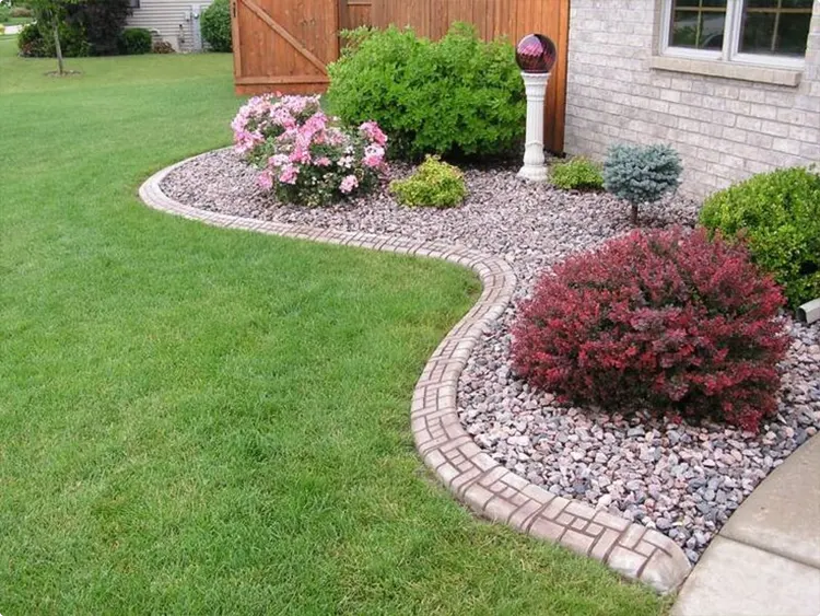Curved Woven Brick Border Around Gray River Rock Bed
