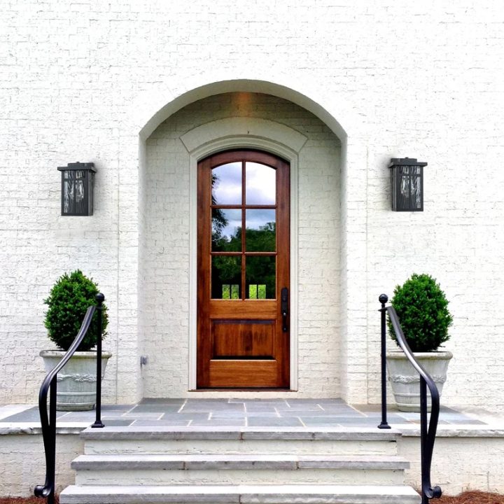 Mahogany Arched Door With Boxwood Topiaries