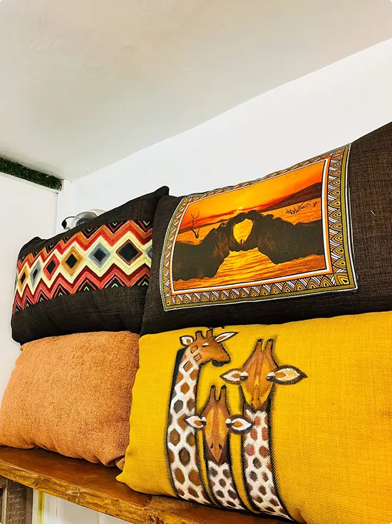 Afrohemian Pillow Grouping on a Wooden Shelf
