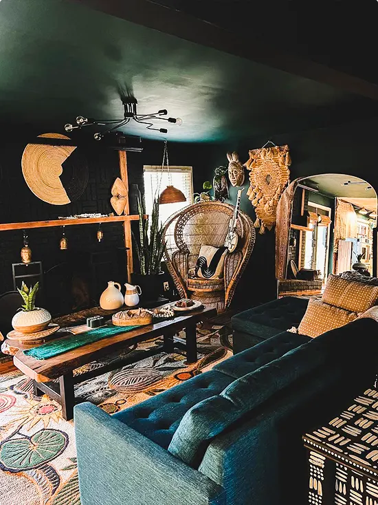 Black Ceiling and Peacock Chair in a Dark Green Living Room