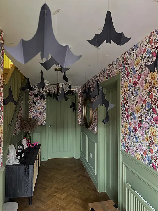 Hanging Bats on Floral Wallpaper