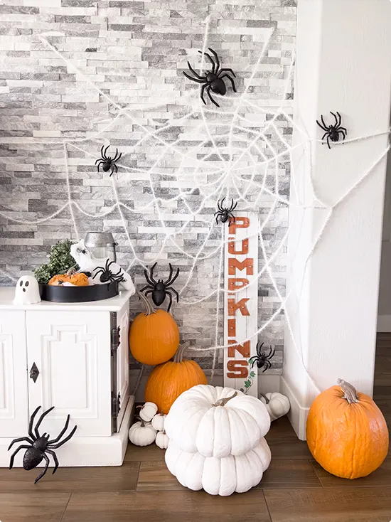 Stacked Pumpkins by a Spiderweb