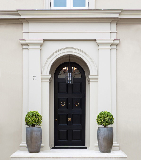Arched Black Paneled Door and White Classic Trim