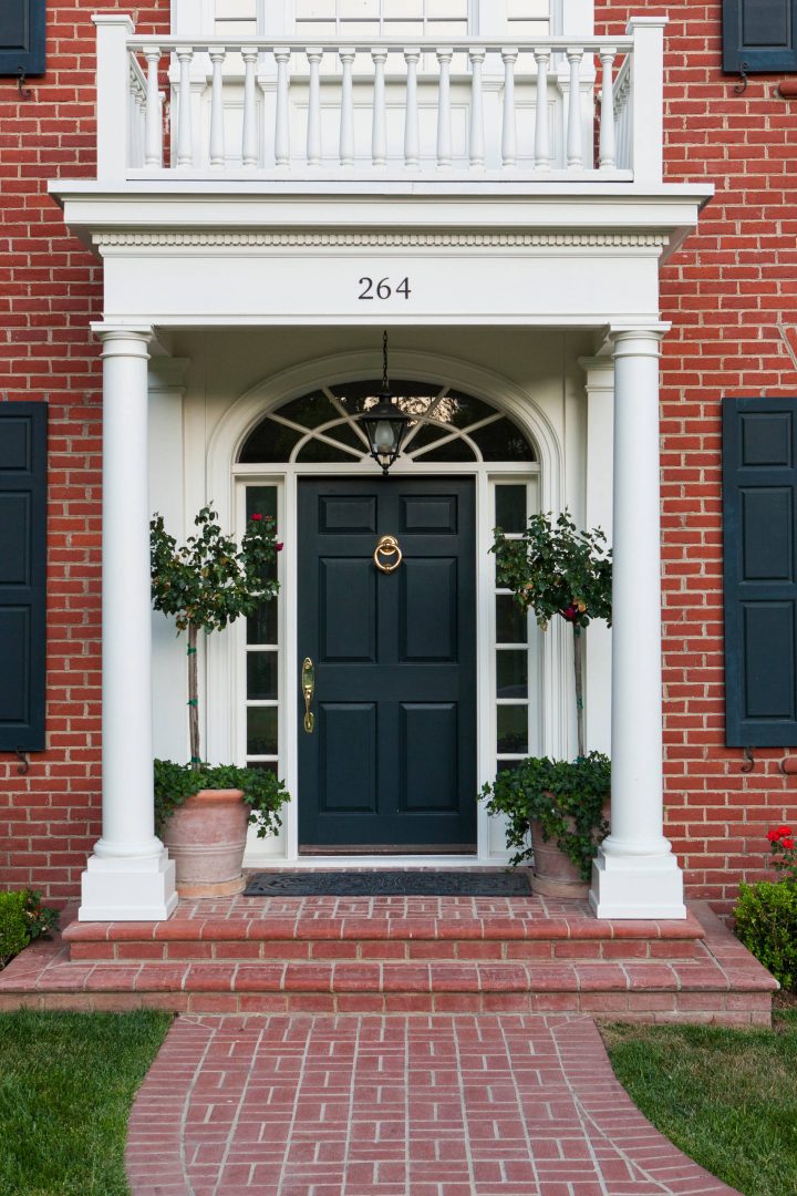 Brick Wall with a Classic Black Door at a Colonial House